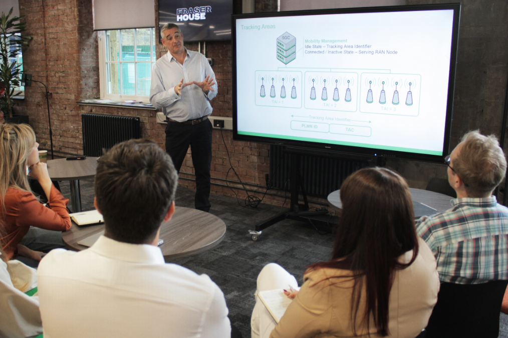 Instructor delivering live training to a group of students
