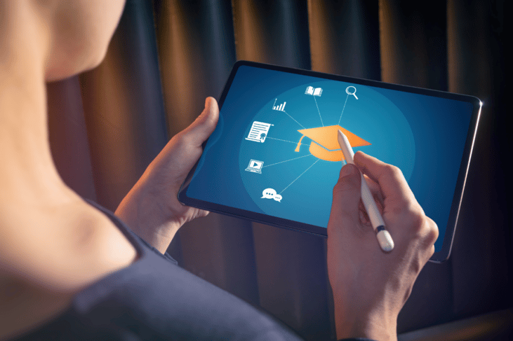 woman using a stylus and tablet to access online learning