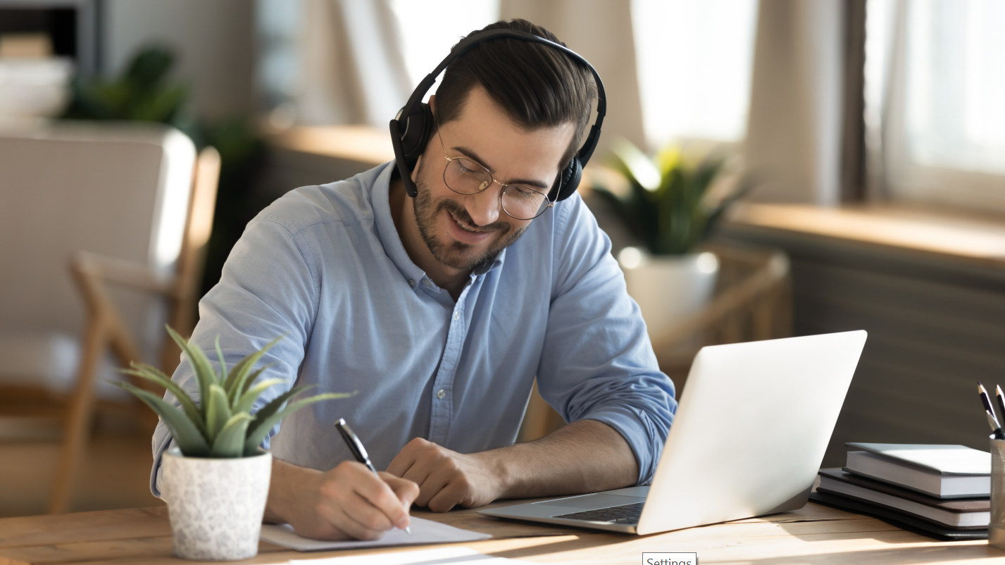 middle aged man with headphones learning online with laptop