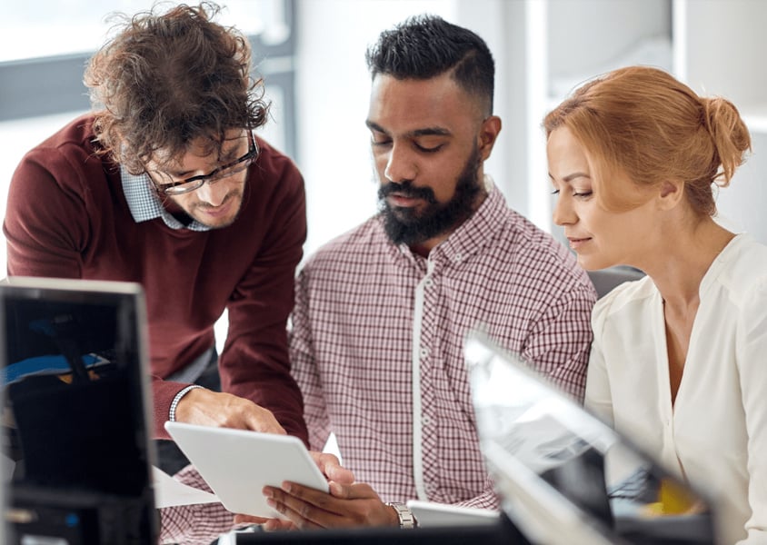 Non-technical team members looking at NetXplore on a tablet