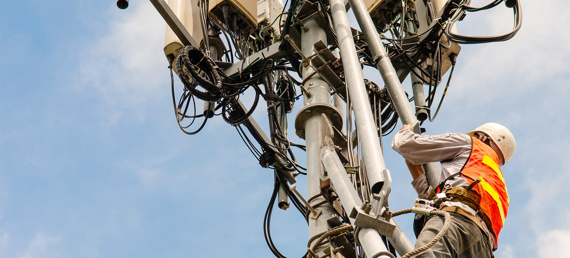 DISH case study header - Engineer working high up on a telecoms antenna
