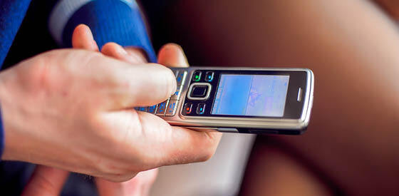 hand pressing button on mobile phone