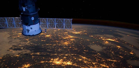 satellite hovering above earth lit up by cities