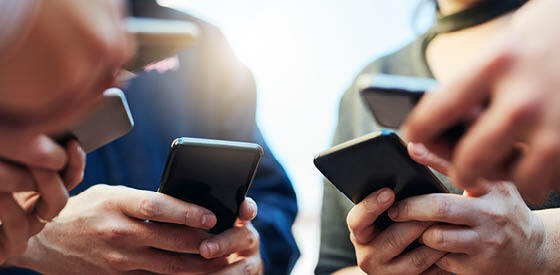 people looking at their mobile phones