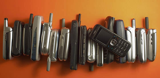 old mobile phones on orange background