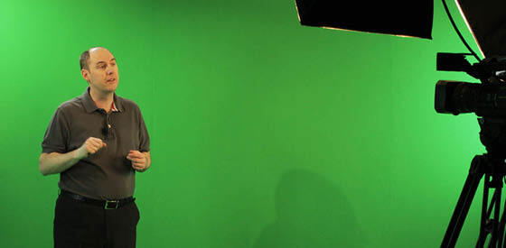 man standing in green screen studio