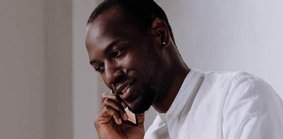 man holding mobile phone to ear