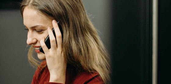 woman holding mobile phone to ear