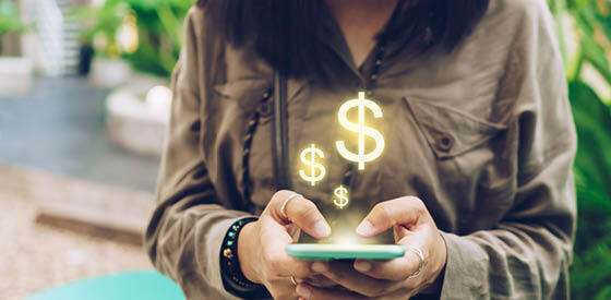 person using mobile phone with dollar signs coming out of phone