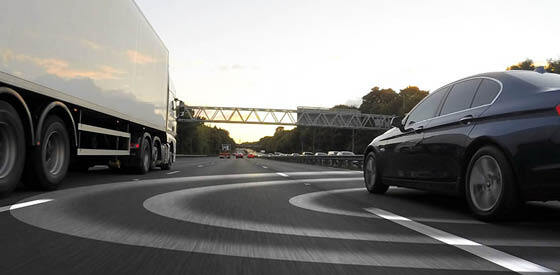 car on road next to truck