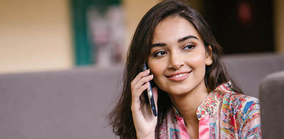 woman holding mobile phone to ear