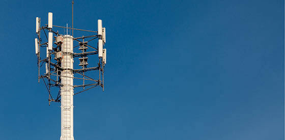 5G radio tower against blue sky background