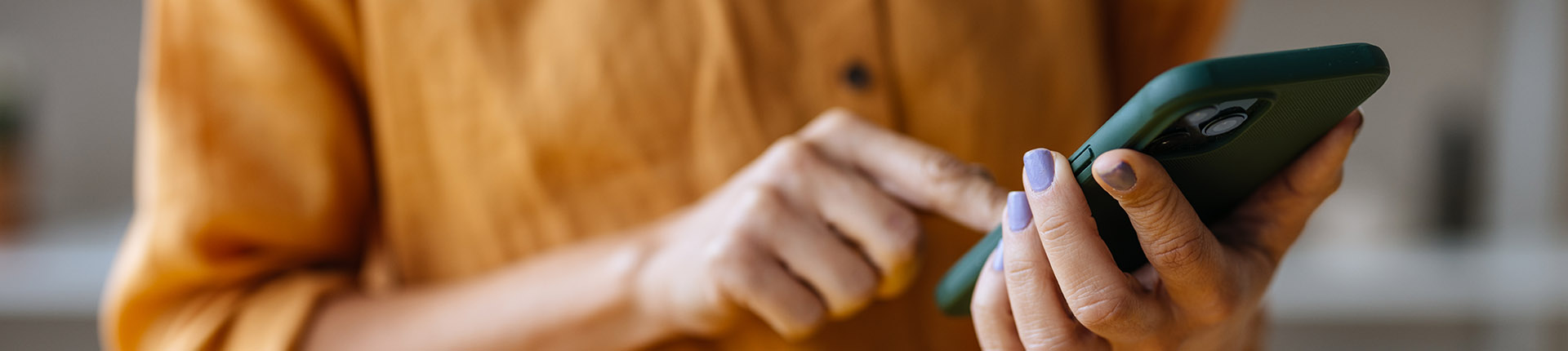 Knowledge Base header - woman holding mobile phone and touching the screen